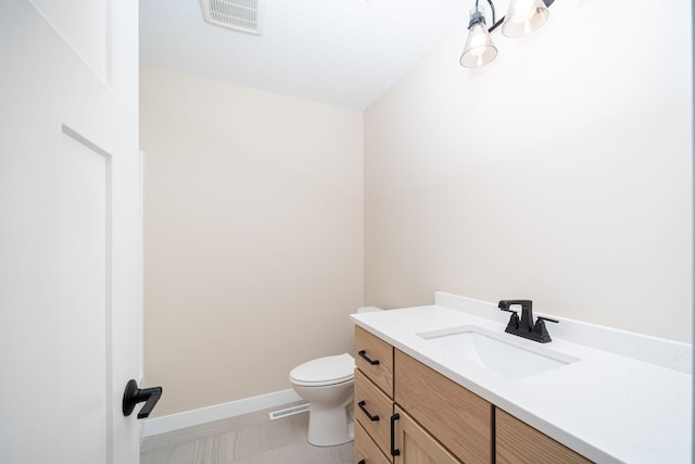 bathroom featuring toilet and vanity