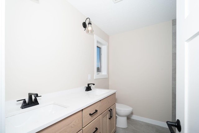 bathroom with toilet, tile patterned floors, and vanity