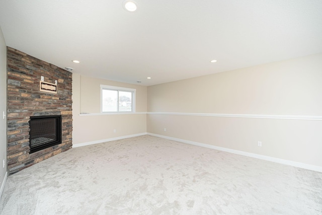 unfurnished living room with a fireplace and carpet floors