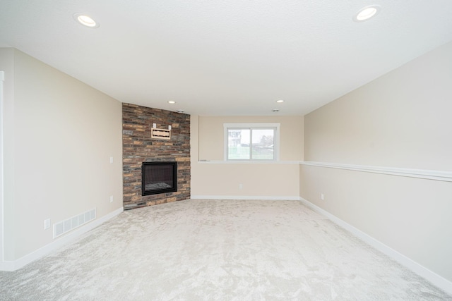 unfurnished living room featuring a fireplace and light carpet