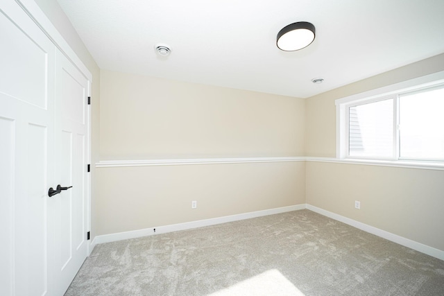 empty room featuring light carpet