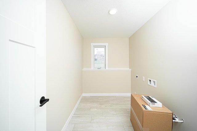 clothes washing area with electric dryer hookup, washer hookup, and light wood-type flooring