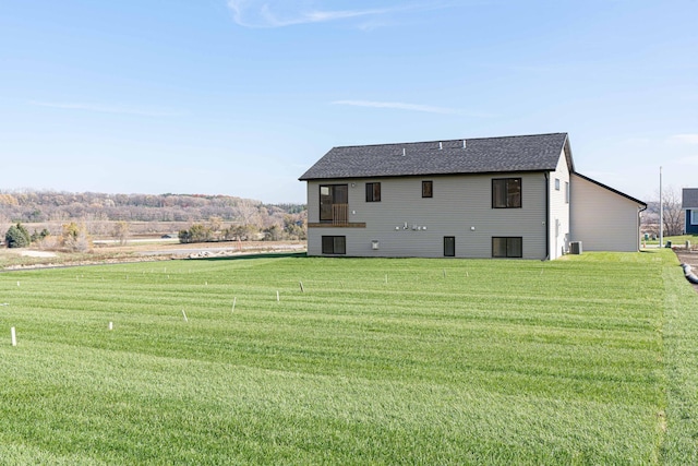 back of property featuring a lawn