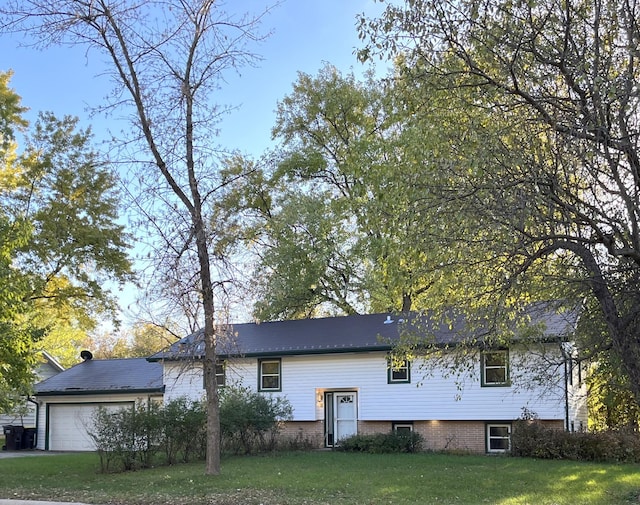 exterior space featuring a lawn and a garage