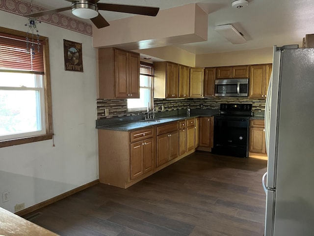 kitchen featuring sink, appliances with stainless steel finishes, dark hardwood / wood-style flooring, and tasteful backsplash