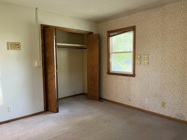 unfurnished bedroom featuring a closet and a textured ceiling