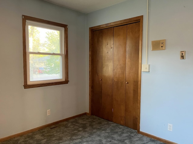 unfurnished bedroom featuring a closet and carpet flooring