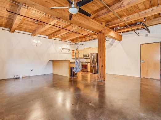 garage featuring stainless steel refrigerator and ceiling fan