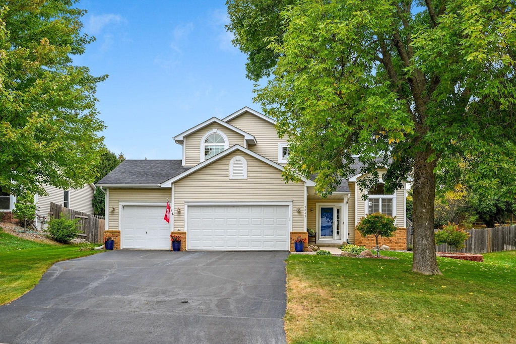 front facade with a front lawn and a garage