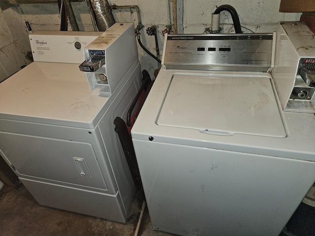 clothes washing area with washer and clothes dryer