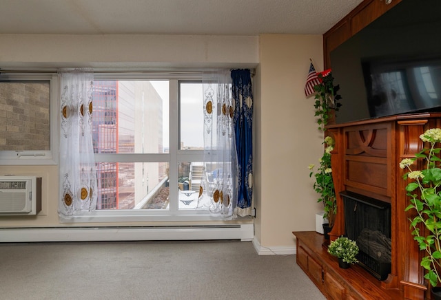 unfurnished living room featuring a baseboard heating unit, light colored carpet, and an AC wall unit