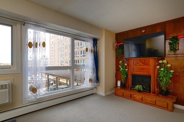 unfurnished living room with a baseboard heating unit, a textured ceiling, and light colored carpet