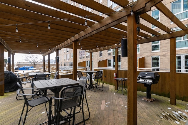 deck featuring grilling area and a pergola