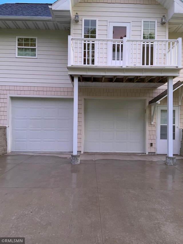 view of front of property with a garage and a balcony