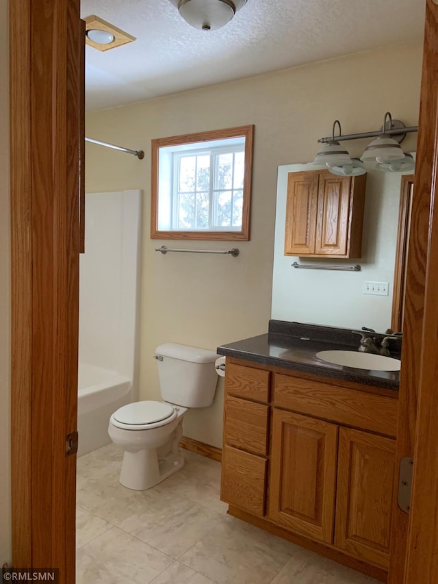 full bathroom featuring toilet, vanity, bathtub / shower combination, and a textured ceiling