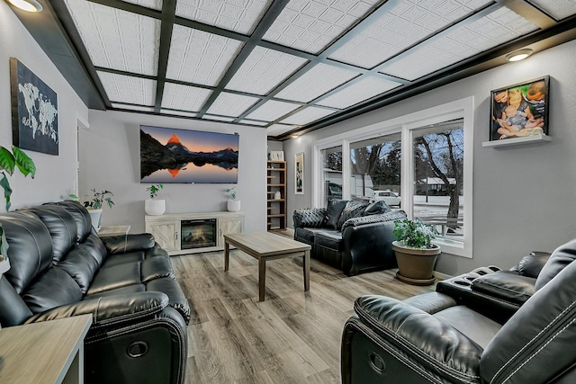 living room featuring a high end fireplace and hardwood / wood-style flooring