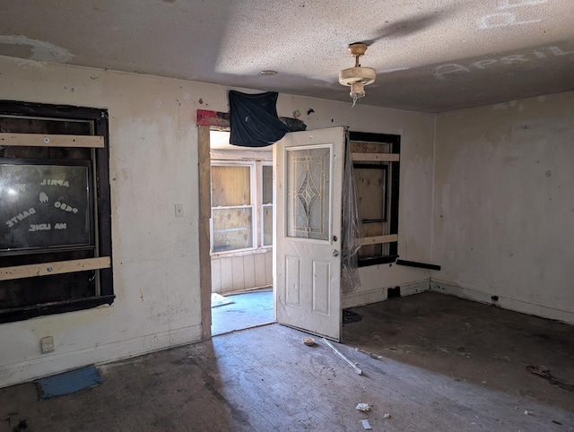 interior space with a textured ceiling