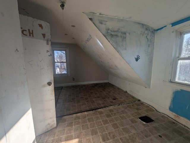 bonus room with lofted ceiling and a healthy amount of sunlight