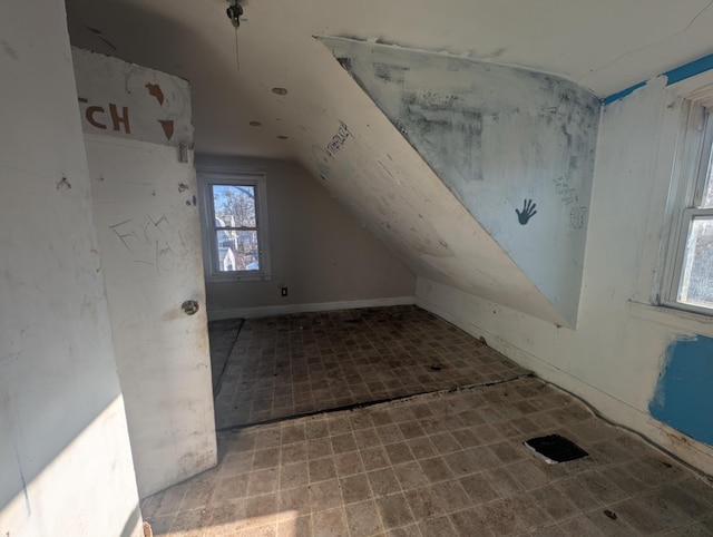 additional living space featuring lofted ceiling