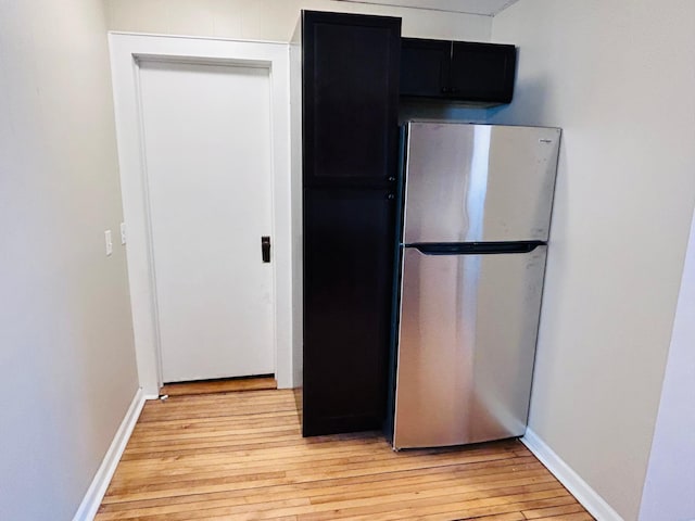 kitchen with light hardwood / wood-style flooring and stainless steel fridge