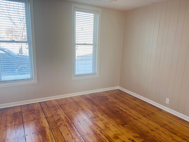 unfurnished room with hardwood / wood-style flooring