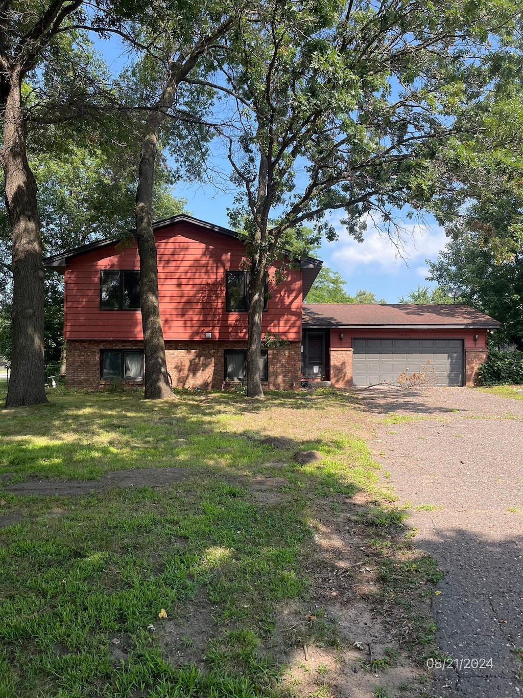 view of front of home with a front lawn and a garage