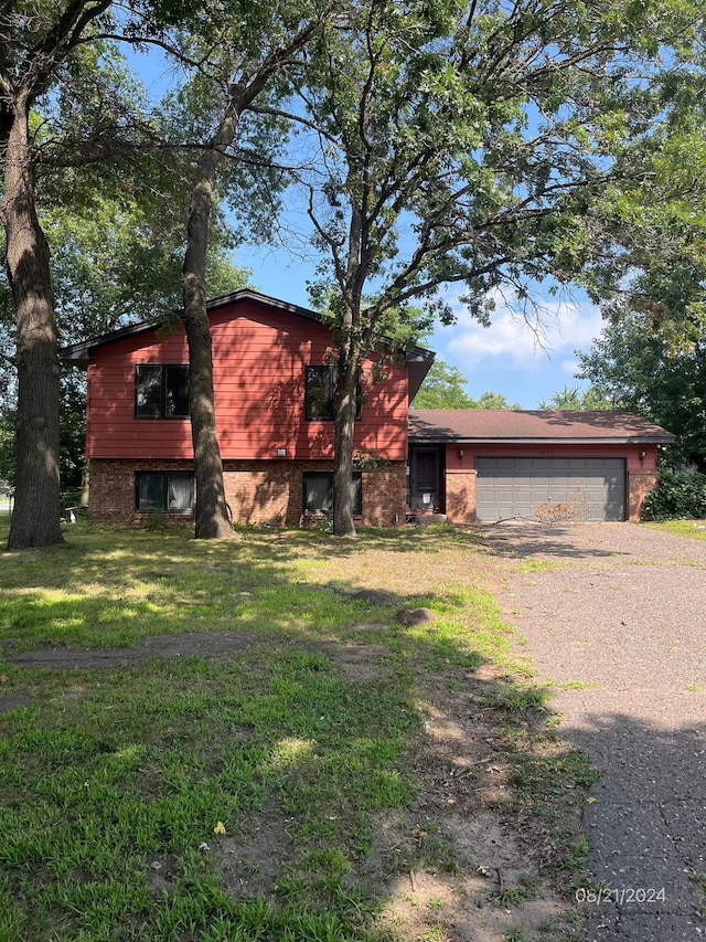 view of front of home with a front lawn and a garage