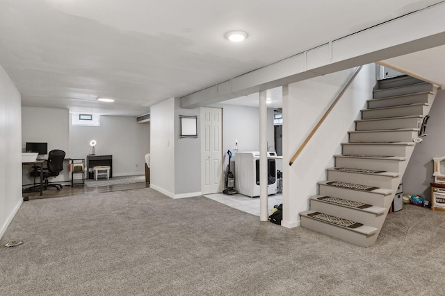 basement with washer and clothes dryer and light carpet