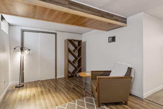 living area featuring hardwood / wood-style flooring and beam ceiling