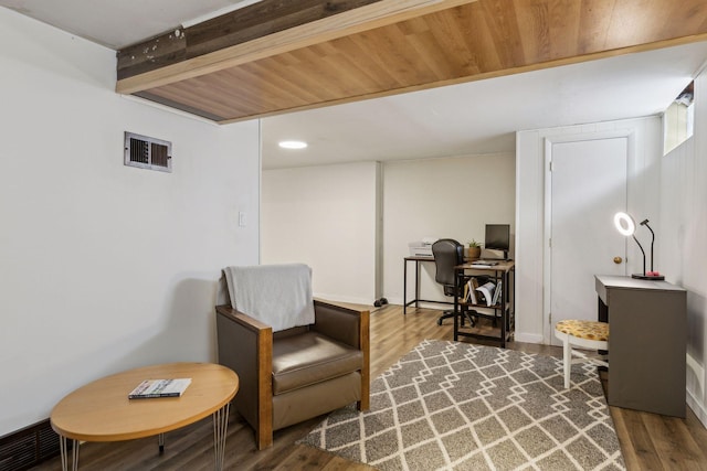 sitting room featuring hardwood / wood-style flooring and beamed ceiling