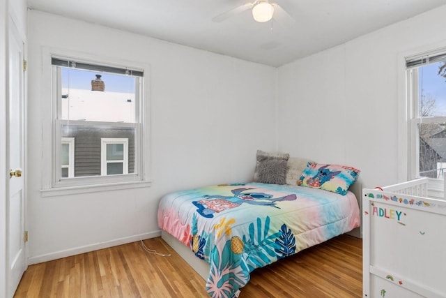 bedroom with ceiling fan and wood-type flooring