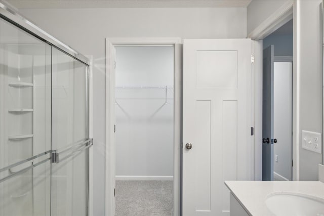 bathroom with an enclosed shower and vanity