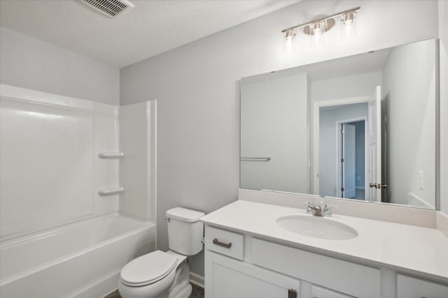 full bathroom featuring a textured ceiling,  shower combination, vanity, and toilet