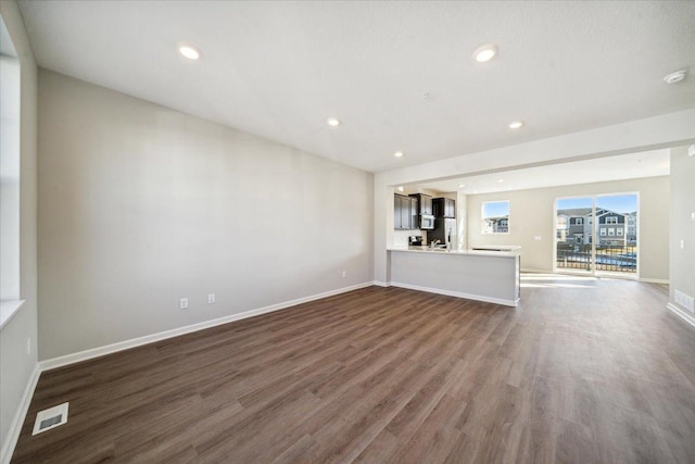 unfurnished living room with dark hardwood / wood-style flooring