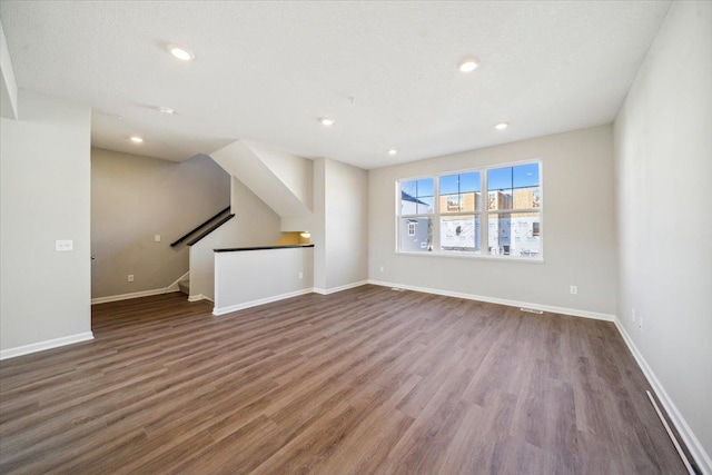 unfurnished living room with dark wood-type flooring