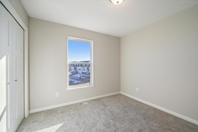 unfurnished bedroom with a closet and carpet