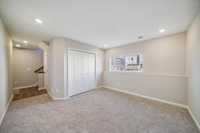 unfurnished bedroom featuring carpet floors and a closet