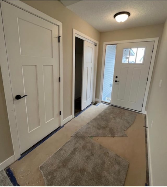 entryway with a textured ceiling