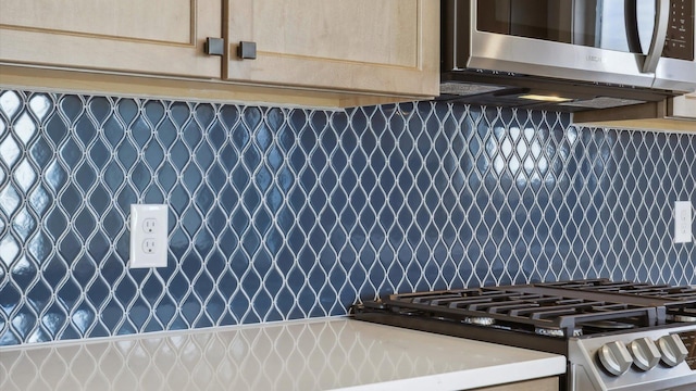 details with stainless steel appliances and light brown cabinets