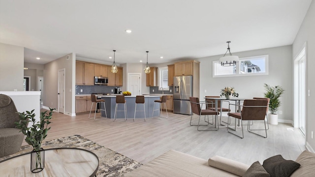 living room with light hardwood / wood-style flooring and sink