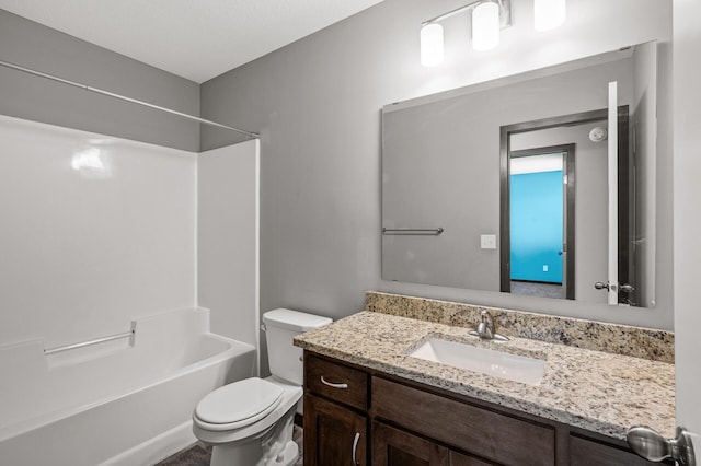 full bathroom featuring bathing tub / shower combination, vanity, and toilet