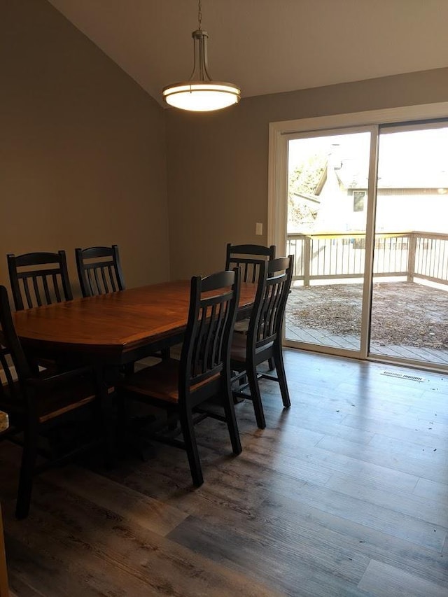 dining space with hardwood / wood-style flooring