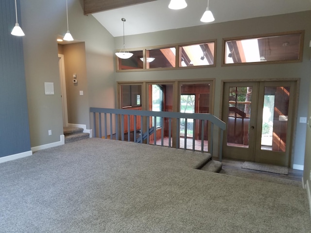 spare room with beamed ceiling, a healthy amount of sunlight, and carpet floors