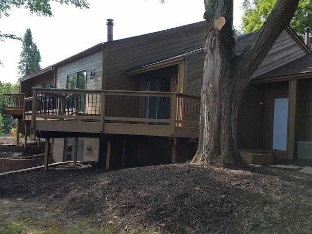 rear view of property with central AC and a deck