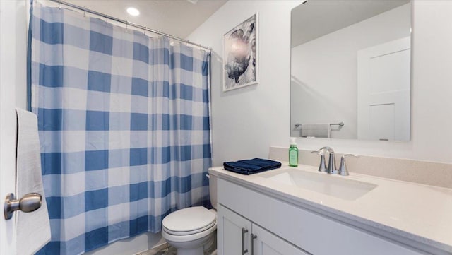 bathroom with toilet and vanity