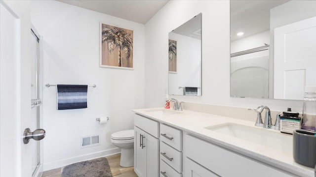 bathroom with toilet and vanity