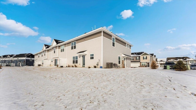 rear view of property with central AC