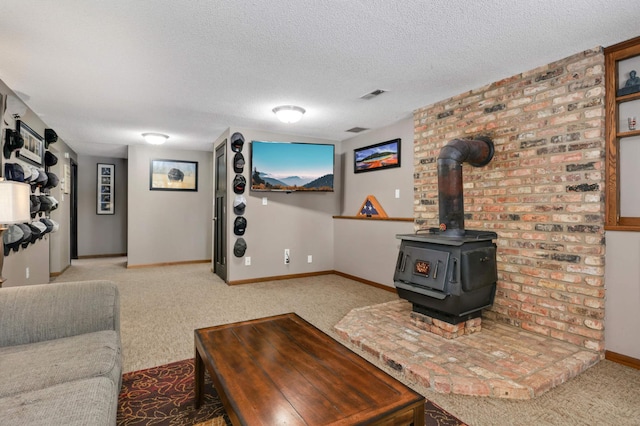 living room with a textured ceiling, light carpet, and a wood stove