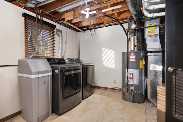 clothes washing area with a healthy amount of sunlight, washing machine and dryer, and gas water heater