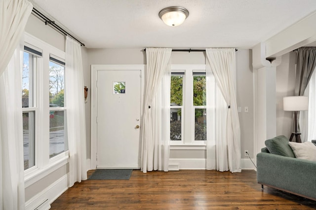 foyer featuring dark hardwood / wood-style flooring and a textured ceiling